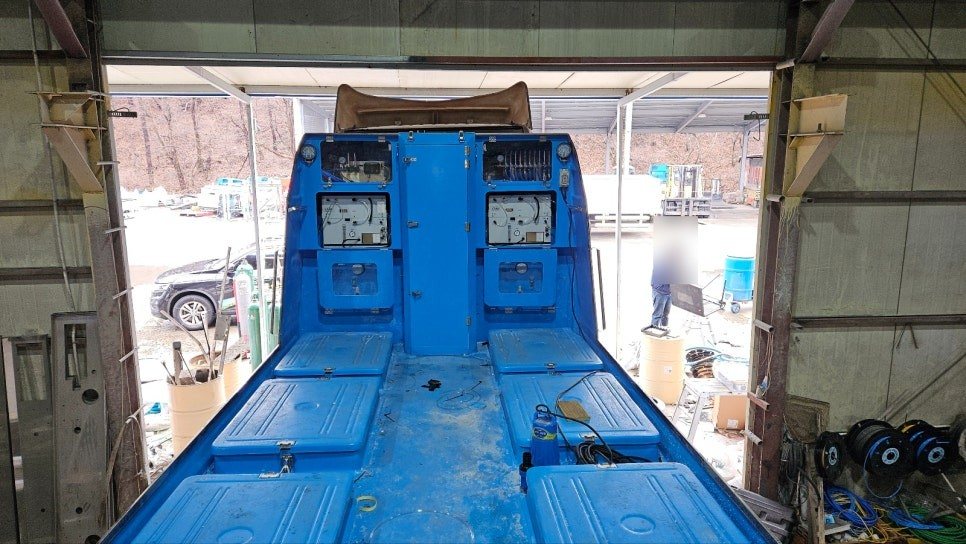 Rear of a live fish transport truck with tank lids and onboard oxygen control panels